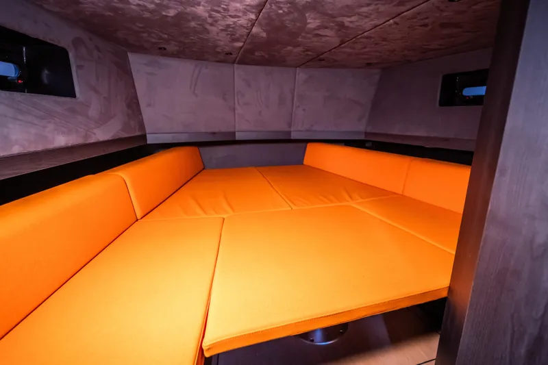  Yacht Photos Pics 2024 Lekker 44 interior with vibrant orange seating in a cozy cabin space.