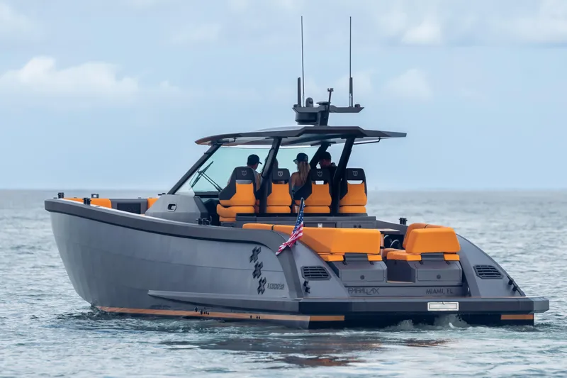  Yacht Photos Pics 2024 Lekker 44 boat cruising on the ocean with orange seating and American flag.