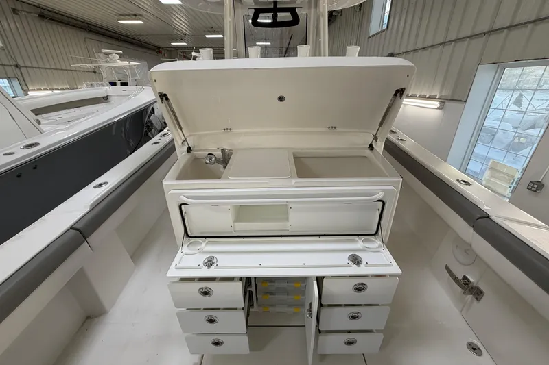 White Yacht Photos Pics 2024 Regulator 34 boat interior with open storage compartments and sink.