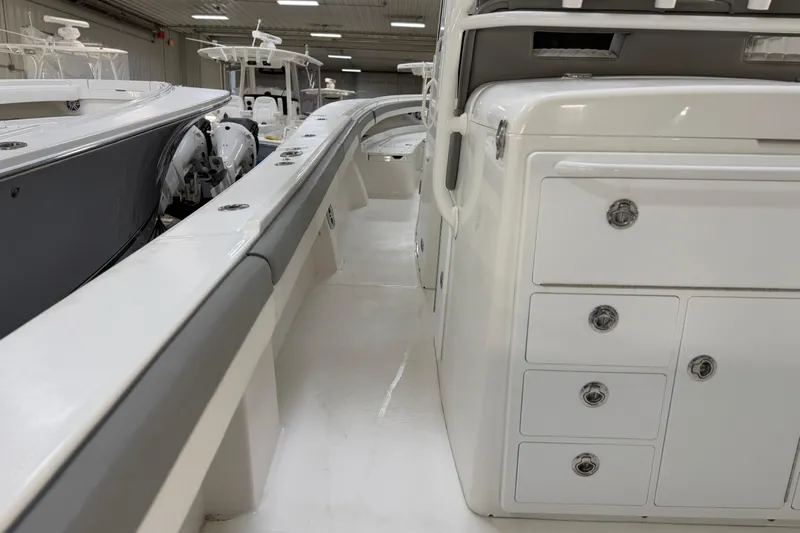 White Yacht Photos Pics 2024 Regulator 34 boat interior with storage compartments and sleek design.