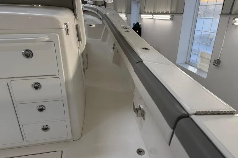 White Yacht Photos Pics 2024 Regulator 34 boat interior with storage compartments and sleek design.