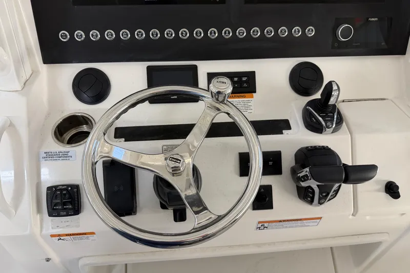White Yacht Photos Pics 2024 Regulator 34 boat dashboard with steering wheel and controls.
