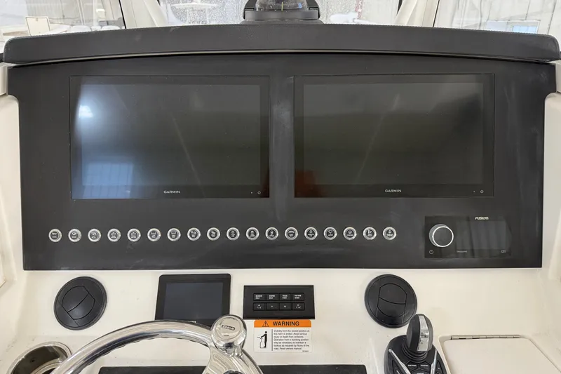 White Yacht Photos Pics 2024 Regulator 34 boat dashboard with dual Garmin screens and control panel.