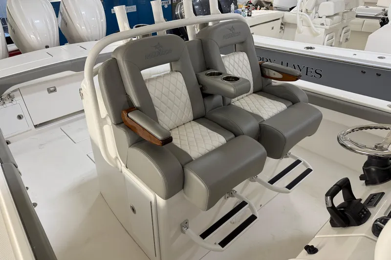 White Yacht Photos Pics 2024 Regulator 34 boat interior with luxurious seating and modern helm controls.
