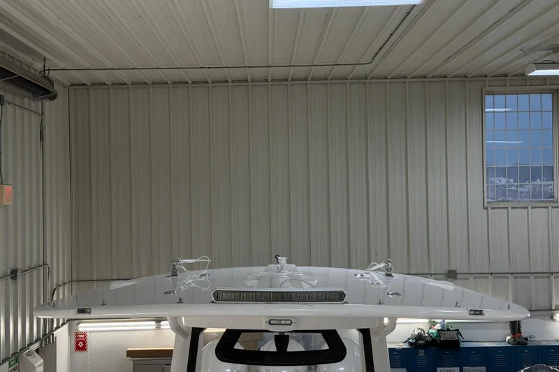 White Yacht Photos Pics 2024 Regulator 34 boat in a metal-walled indoor storage facility.