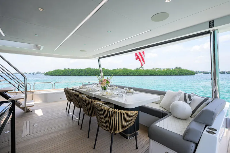  Yacht Photos Pics Luxurious 2024 Sirena 88 yacht interior with elegant dining area overlooking serene waters.