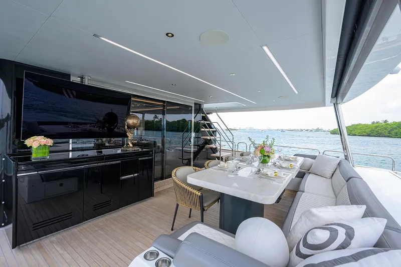  Yacht Photos Pics Luxurious 2024 Sirena 88 yacht deck with elegant dining area and scenic water view.
