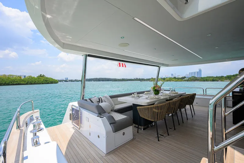  Yacht Photos Pics Luxurious 2024 Sirena 88 yacht deck with dining area overlooking serene waters.