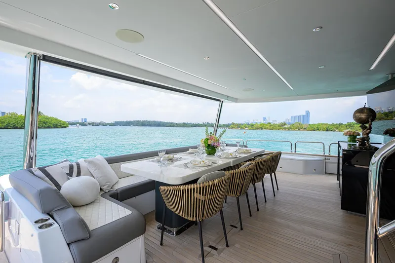  Yacht Photos Pics Luxurious 2024 Sirena 88 yacht with elegant dining area overlooking serene waters.