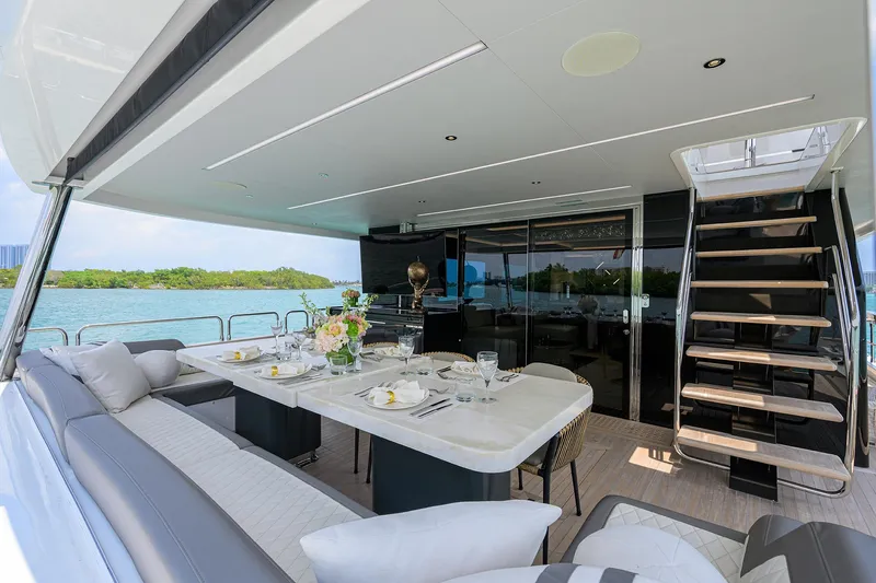  Yacht Photos Pics Luxurious 2024 Sirena 88 yacht deck with elegant dining setup and scenic ocean view.