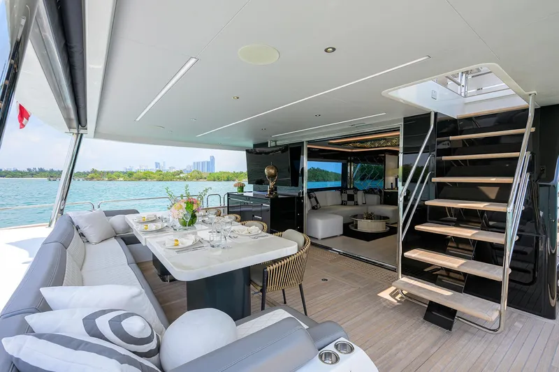  Yacht Photos Pics Luxurious 2024 Sirena 88 yacht interior with elegant dining area and modern staircase.