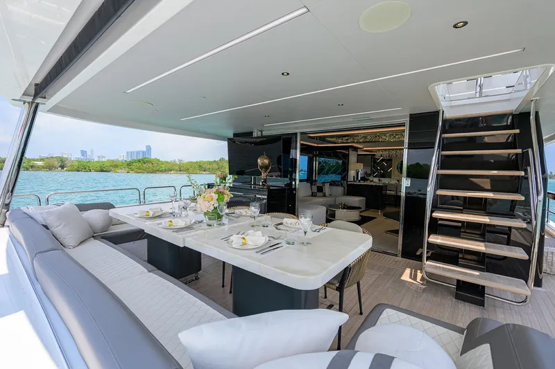  Yacht Photos Pics Luxurious 2024 Sirena 88 yacht interior with elegant dining area and scenic ocean view.