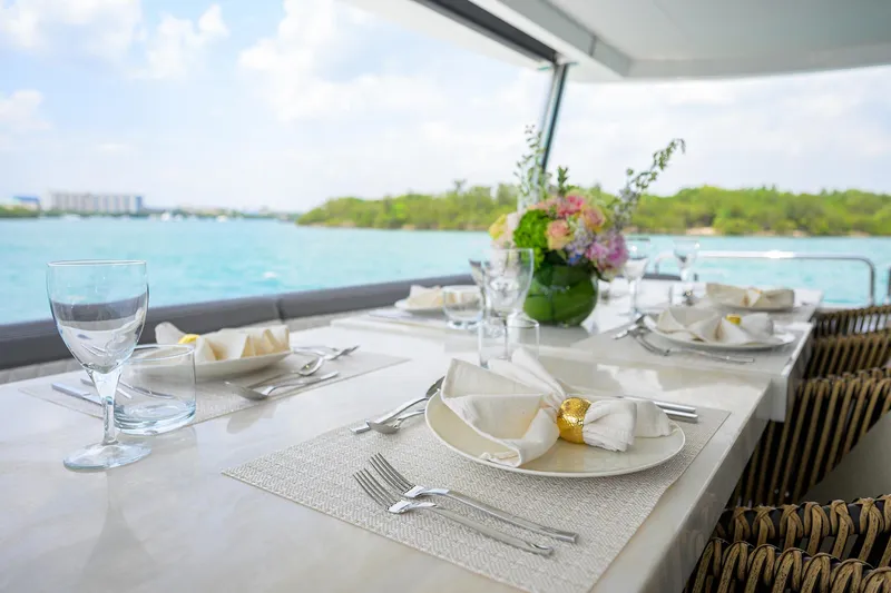  Yacht Photos Pics Elegant dining setup on 2024 Sirena 88 yacht with ocean view.