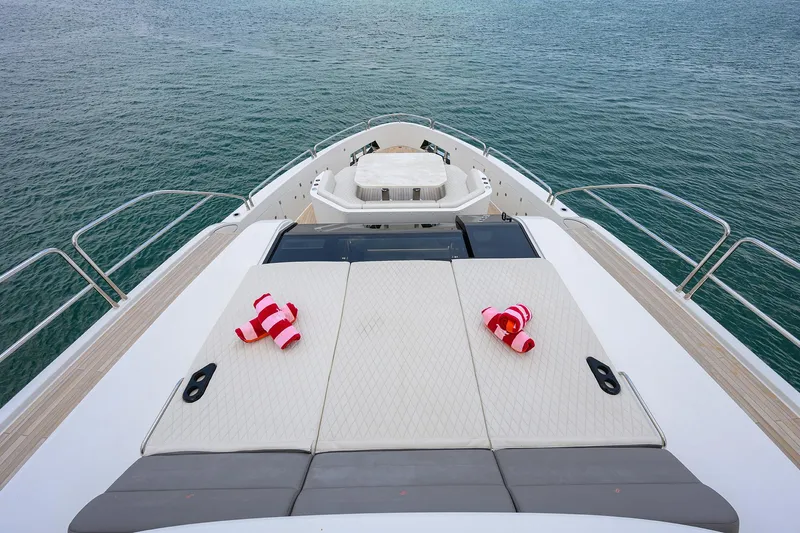  Yacht Photos Pics Luxury Sirena 88 yacht deck with sun loungers, 2024 model, overlooking serene ocean waters.