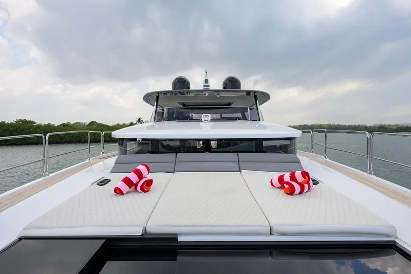  Yacht Photos Pics 2024 Sirena 88 yacht deck with sun loungers and striped towels, under cloudy sky.