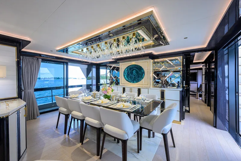  Yacht Photos Pics Luxurious dining area on 2024 Sirena 88 yacht with elegant table setting and ocean view.