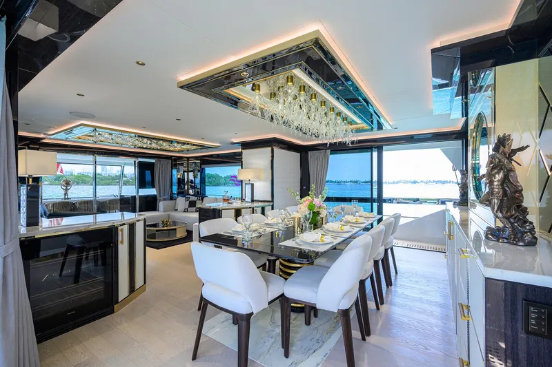  Yacht Photos Pics Luxurious interior of 2024 Sirena 88 yacht with elegant dining area and panoramic views.
