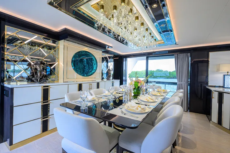  Yacht Photos Pics Luxurious dining area in 2024 Sirena 88 yacht with elegant decor and scenic views.