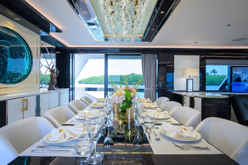  Yacht Photos Pics Luxurious dining area on 2024 Sirena 88 yacht, elegantly set table with modern decor.
