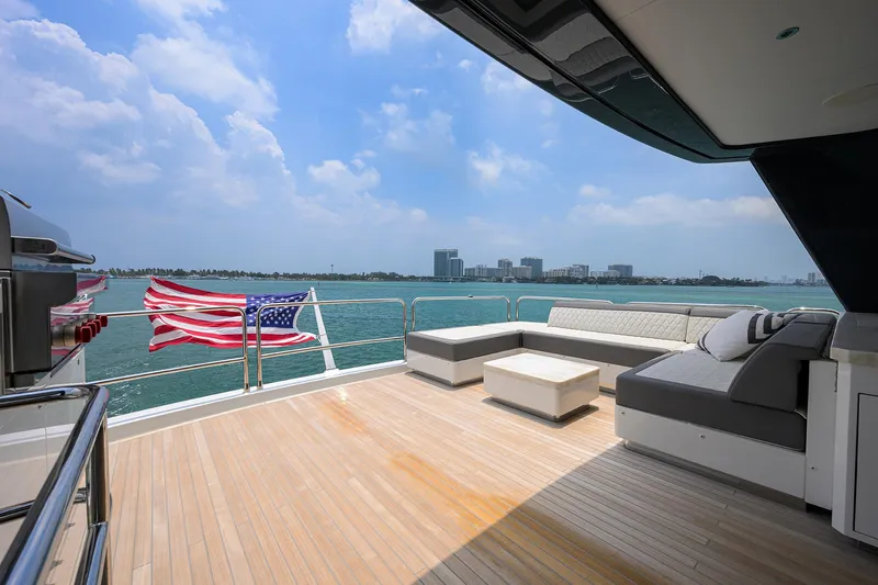  Yacht Photos Pics Luxurious 2024 Sirena 88 yacht deck with seating, ocean view, and American flag.