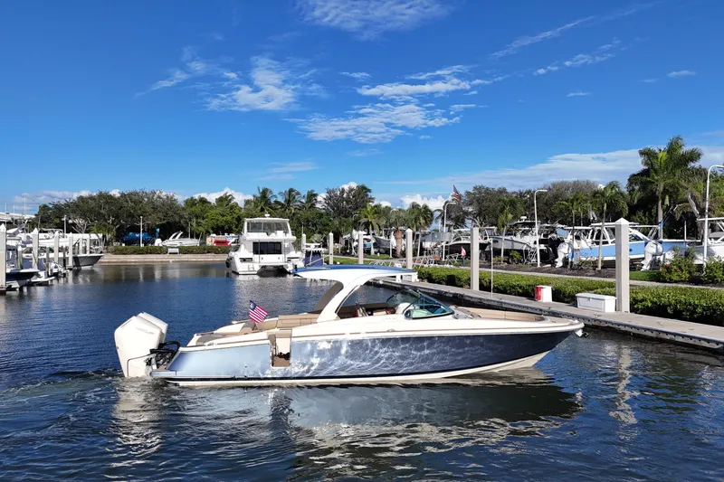 Yacht Photos Pics 2026 Chris-Craft Launch 35 GT boat in marina, clear blue sky, palm trees.