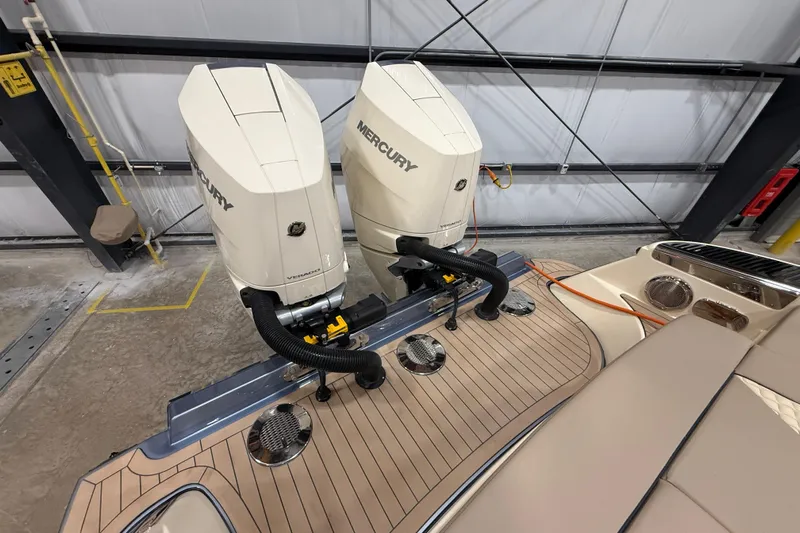  Yacht Photos Pics 2026 Chris-Craft Launch 35 GT with dual Mercury outboard engines in a garage setting.