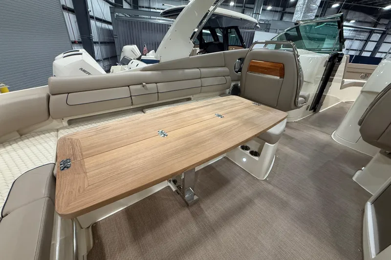  Yacht Photos Pics 2026 Chris-Craft Launch 35 GT interior with wooden table and beige seating.