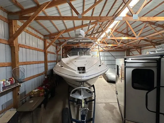  Yacht Photos Pics 2005 Cruisers Yachts 340 Express stored in a wooden garage.