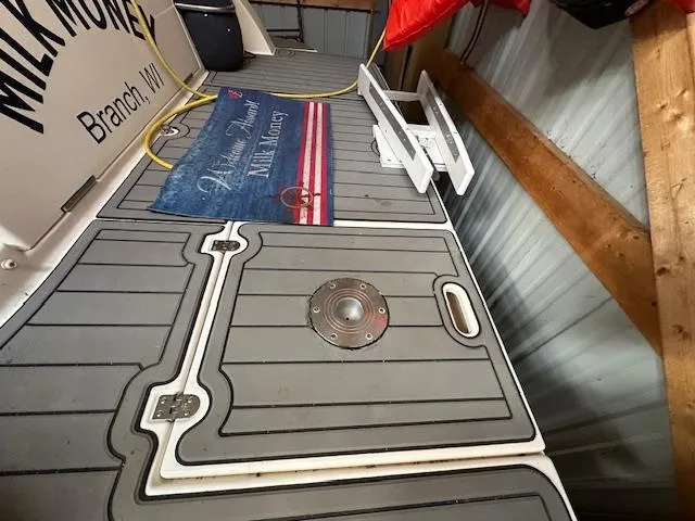  Yacht Photos Pics 2005 Cruisers Yachts 340 Express deck with mat and ladder in storage.