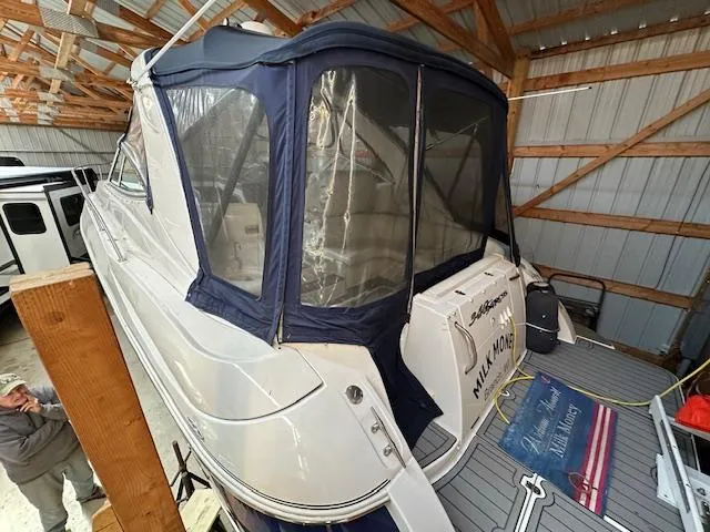  Yacht Photos Pics 2005 Cruisers Yachts 340 Express in storage, featuring a blue canopy and white exterior.