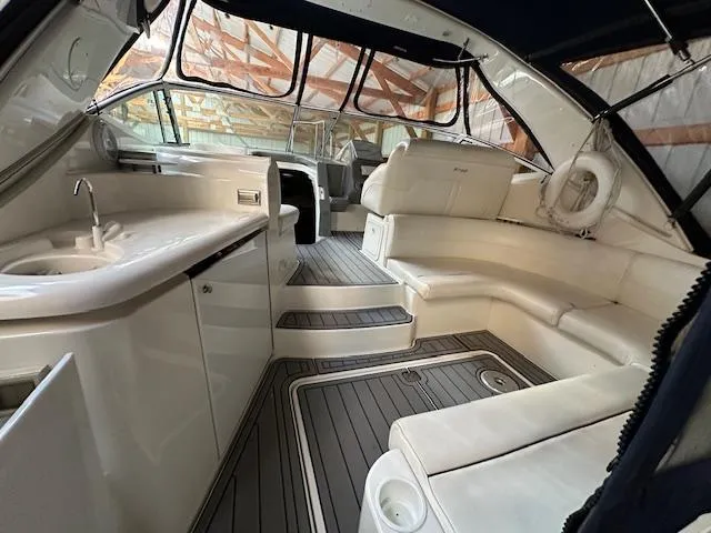  Yacht Photos Pics 2005 Cruisers Yachts 340 Express interior with white seating and kitchenette.