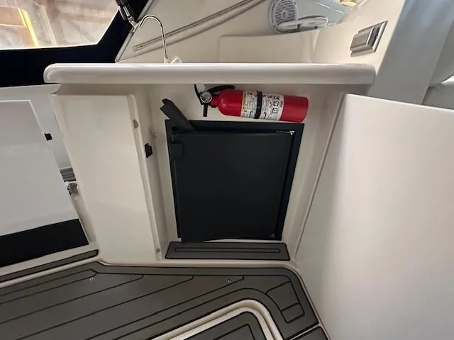  Yacht Photos Pics 2005 Cruisers Yachts 340 Express interior with fire extinguisher and storage compartment.