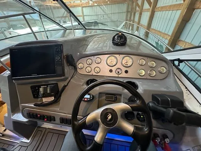  Yacht Photos Pics 2005 Cruisers Yachts 340 Express dashboard with steering wheel and navigation instruments.