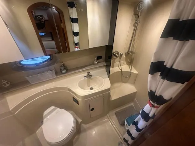  Yacht Photos Pics 2005 Cruisers Yachts 340 Express bathroom with shower, sink, and toilet.