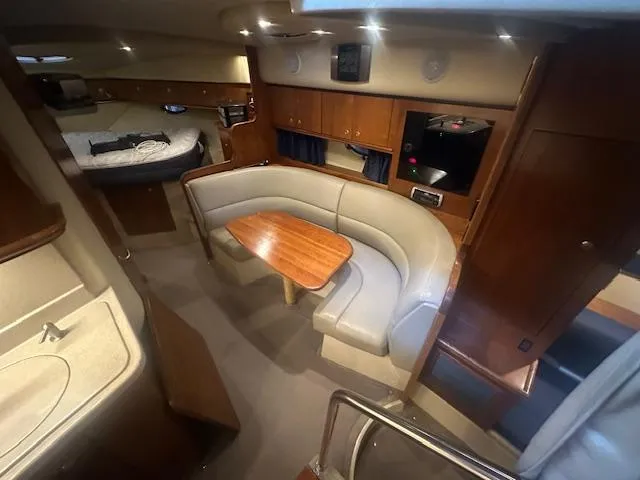  Yacht Photos Pics 2005 Cruisers Yachts 340 Express interior with dining area, kitchenette, and sleeping quarters.