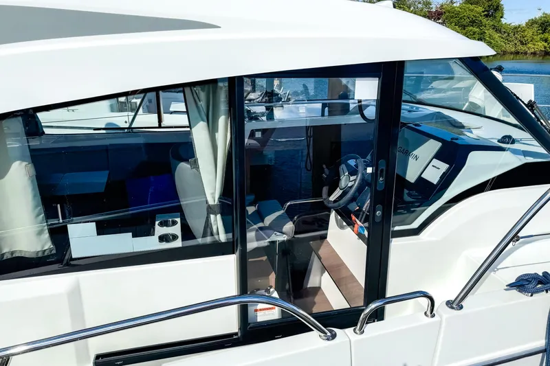  Yacht Photos Pics 2023 Beneteau Antares 11 boat interior with steering wheel and navigation system.