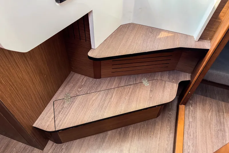  Yacht Photos Pics Interior of 2023 Beneteau Antares 11, featuring wooden cabinetry and storage space.