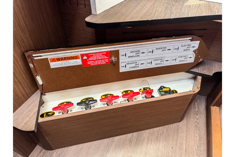  Yacht Photos Pics Electrical panel of 2023 Beneteau Antares 11 boat with labeled switches and warning signs.