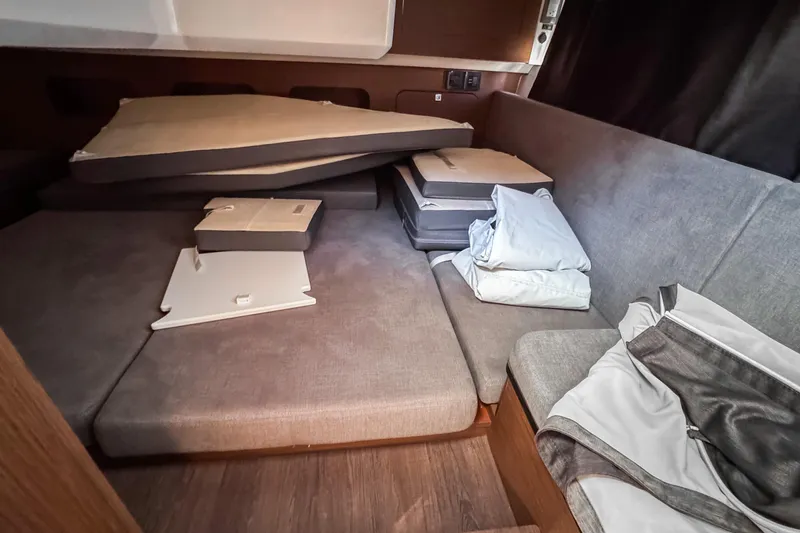  Yacht Photos Pics Interior cabin of 2023 Beneteau Antares 11 with cushions and bedding.