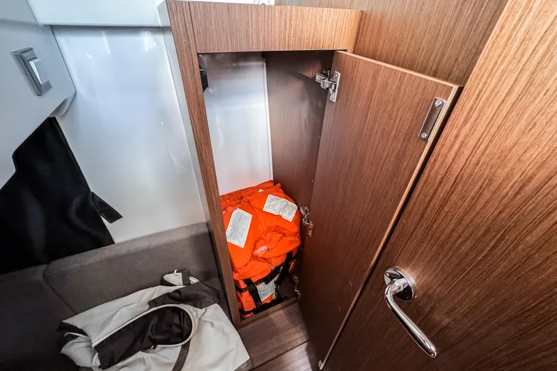  Yacht Photos Pics Storage cabinet with life jackets on a 2023 Beneteau Antares 11 boat.