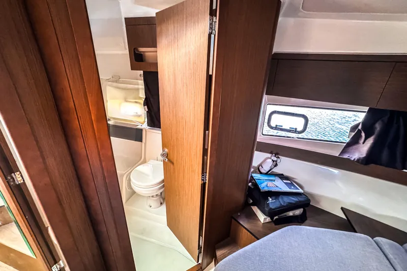  Yacht Photos Pics Interior of 2023 Beneteau Antares 11, featuring a compact bathroom and cozy cabin space.