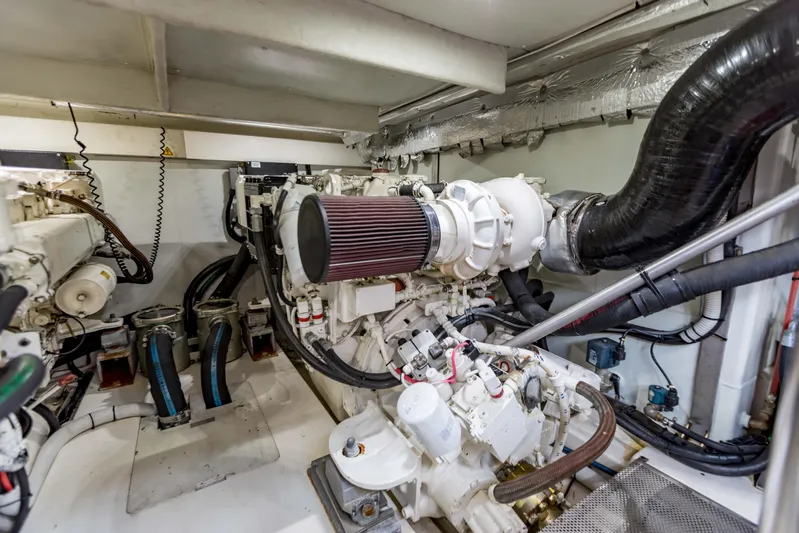 Golden Sun Yacht Photos Pics Engine room of a 2011 Azimut 58 yacht, showcasing mechanical components and piping.