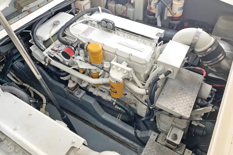 Makai Yacht Photos Pics Engine compartment of a 2000 Sea Ray 410 Sundancer boat, showcasing detailed machinery.