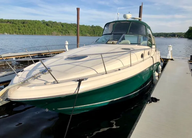 Serenity Yacht Photos Pics 2004 Sea Ray 340 Sundancer docked on a serene lake with lush green surroundings.