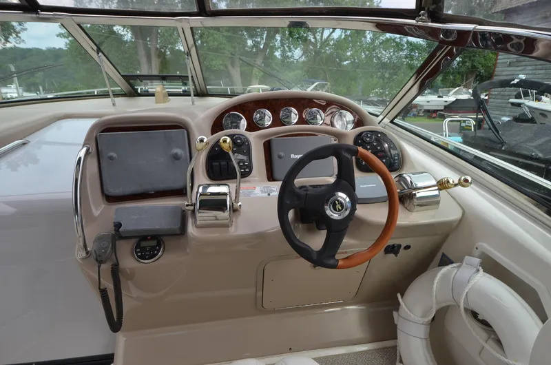 Serenity Yacht Photos Pics 2004 Sea Ray 340 Sundancer helm with steering wheel and control panel.