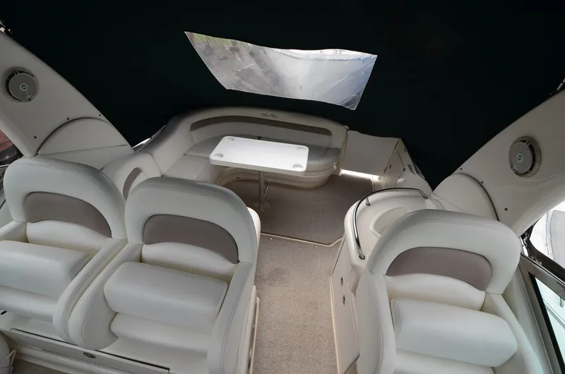 Serenity Yacht Photos Pics 2004 Sea Ray 340 Sundancer interior with white seating and table.
