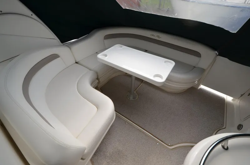 Serenity Yacht Photos Pics 2004 Sea Ray 340 Sundancer interior with white seating and table.