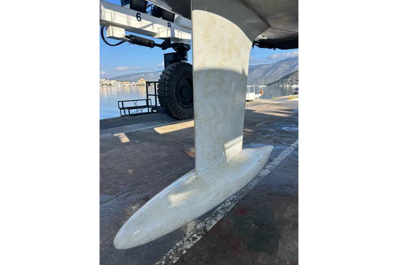 Deiopea Yacht Photos Pics Keel of 2013 Italia Yachts IY13.98 sailboat on dry dock with scenic background.