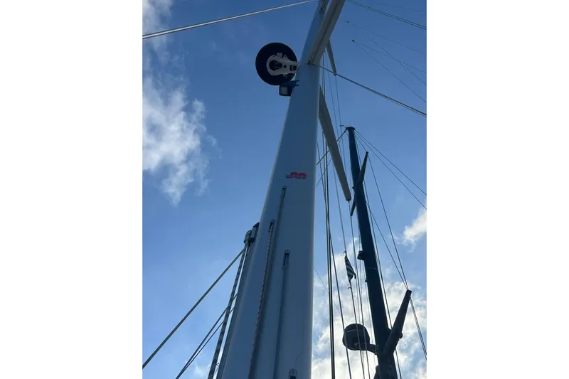 Deiopea Yacht Photos Pics Mast of 2013 Italia Yachts IY13.98 sailboat against a blue sky.