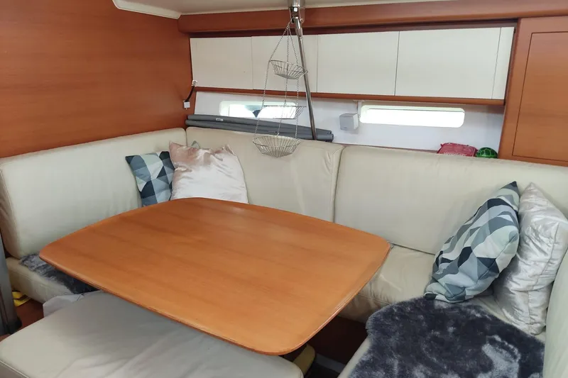 Deiopea Yacht Photos Pics Luxurious interior of 2013 Italia Yachts IY13.98 with cozy seating and wooden table.